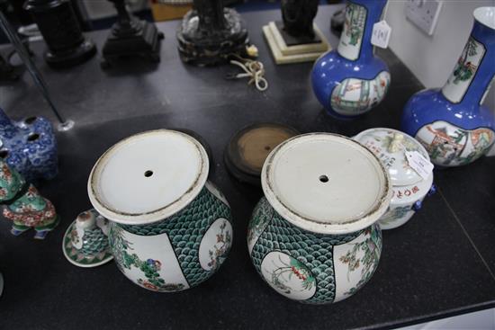 A pair of Chinese famille verte baluster vases and covers, late 19th century, 29.5cm, later drilled for lamp fittings, wood stands